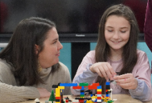 Teacher Sara Cardin works with a student.