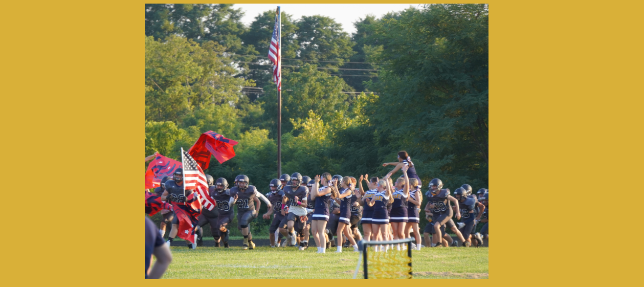 football players entering field