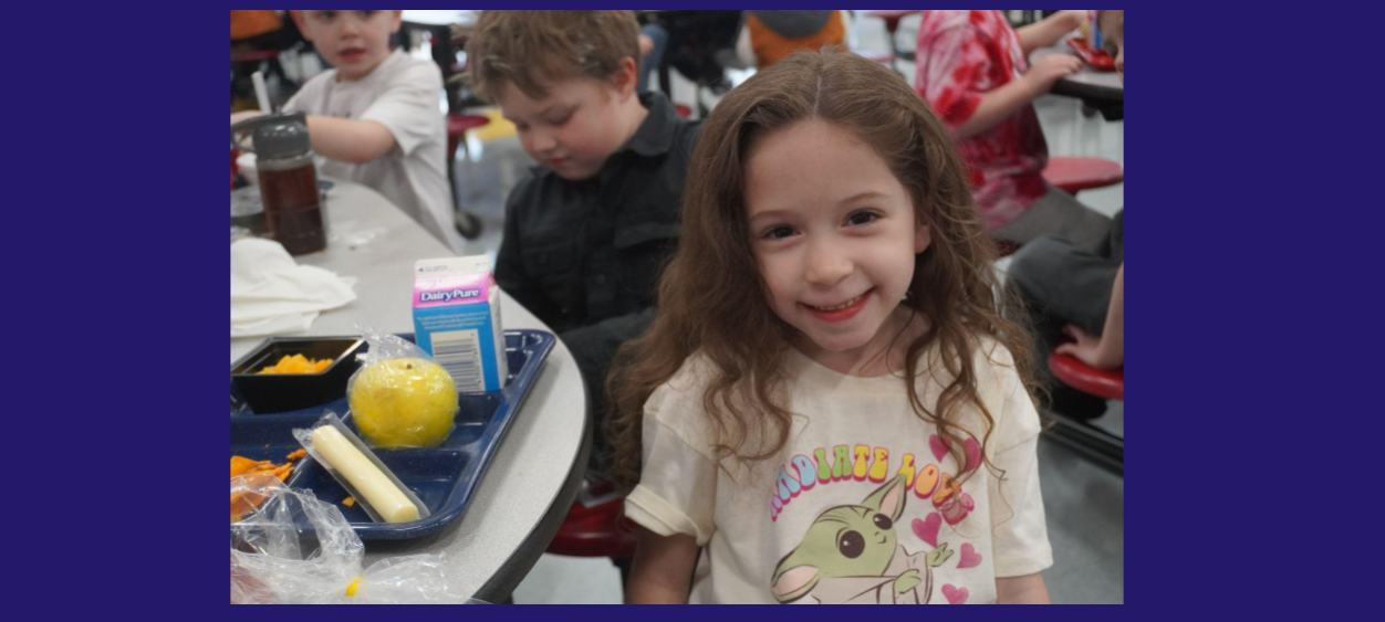 Little Girl Smiling at Lunch