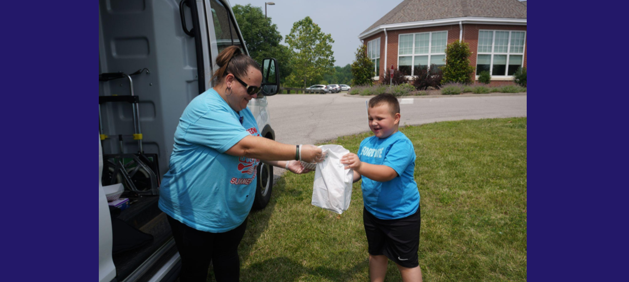 child receiving lunch