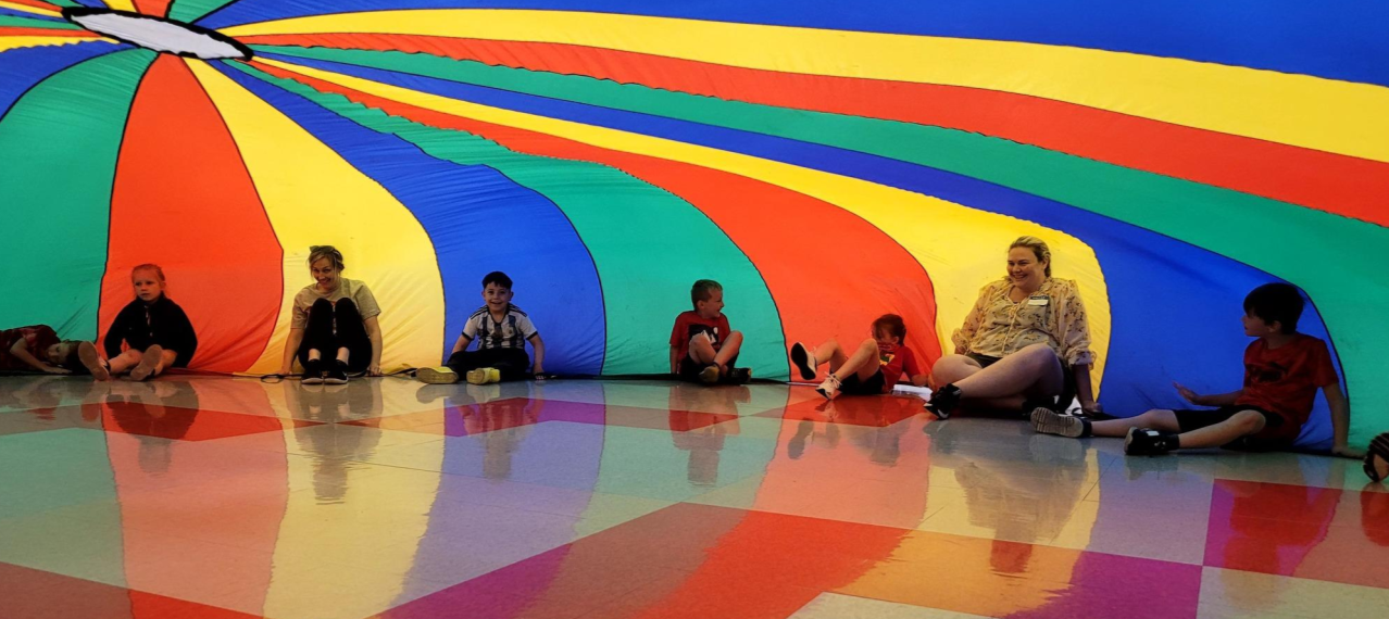 elementary students inside the  parachute